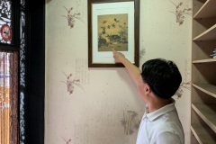 The owner telling us about the art on the walls.